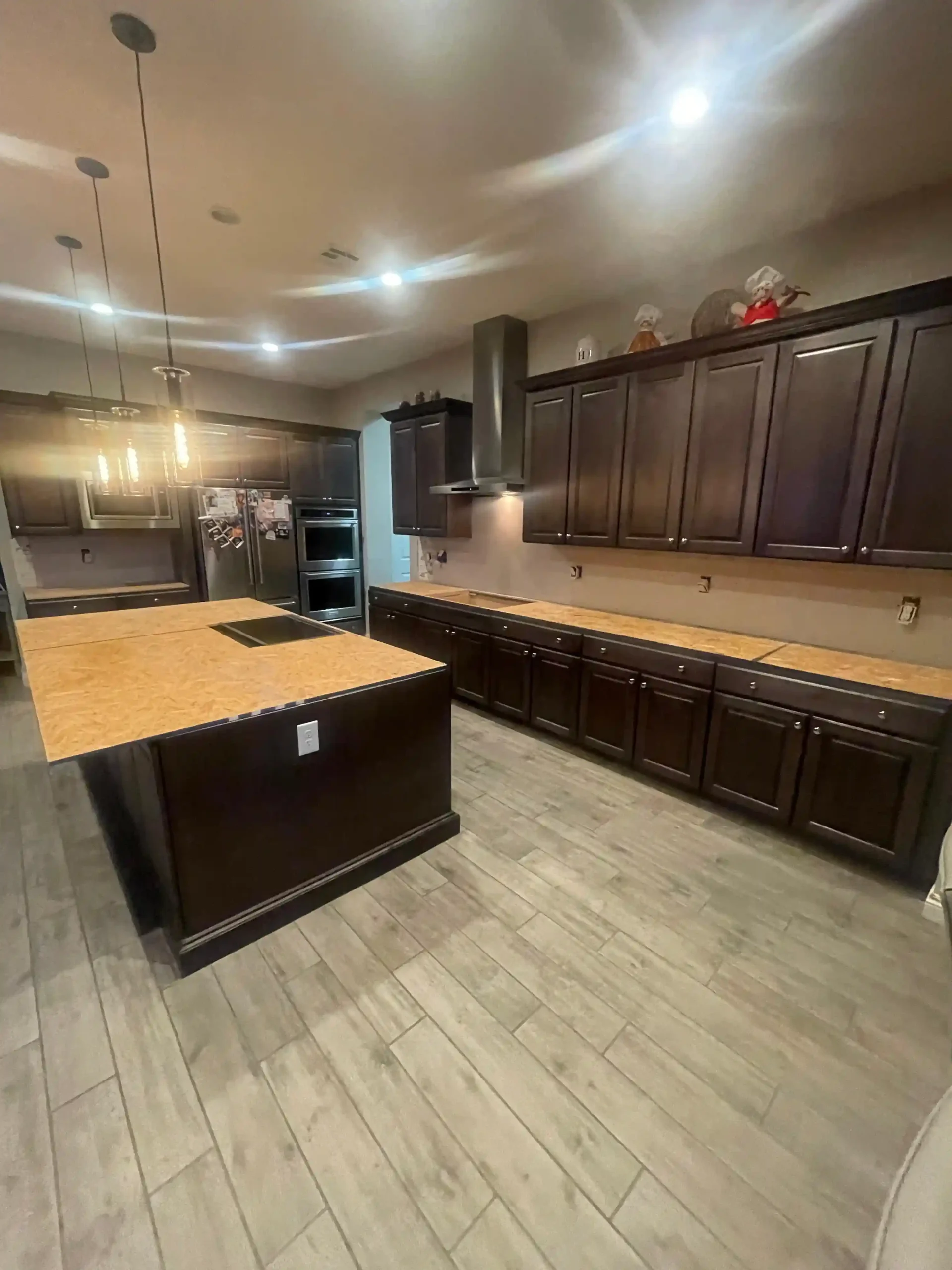 Wide view of completed kitchen remodel with island and cabinetry by Pro Vegas Home Remodel