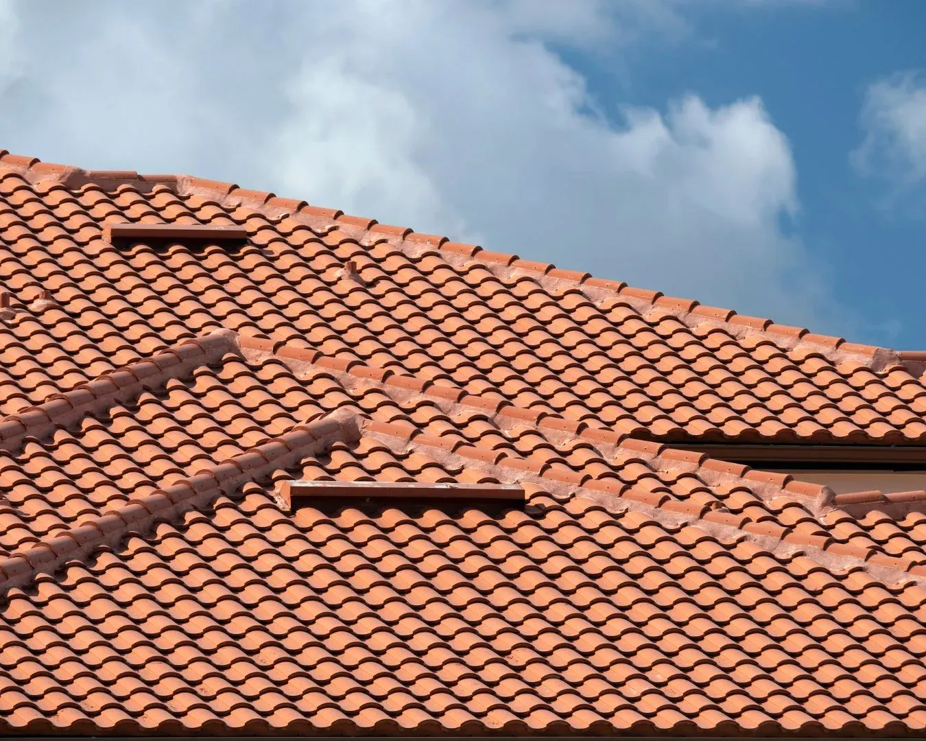 Roofing team installing wind‑resistant roof tiles for durability