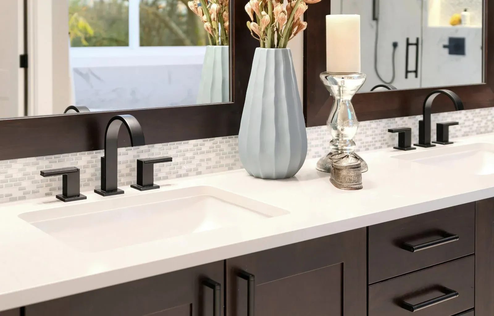 Bright bathroom space featuring double sink vanity and large mirrors