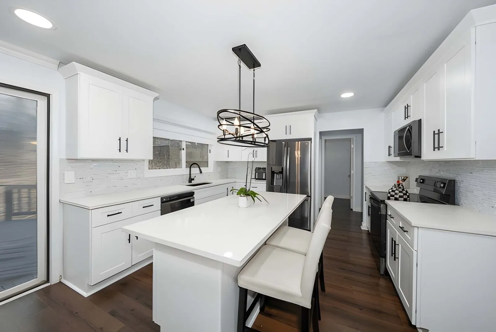 Kitchen and Bathroom Remodeling in Spring Valley showcasing an open-concept kitchen with island seating and updated lighting